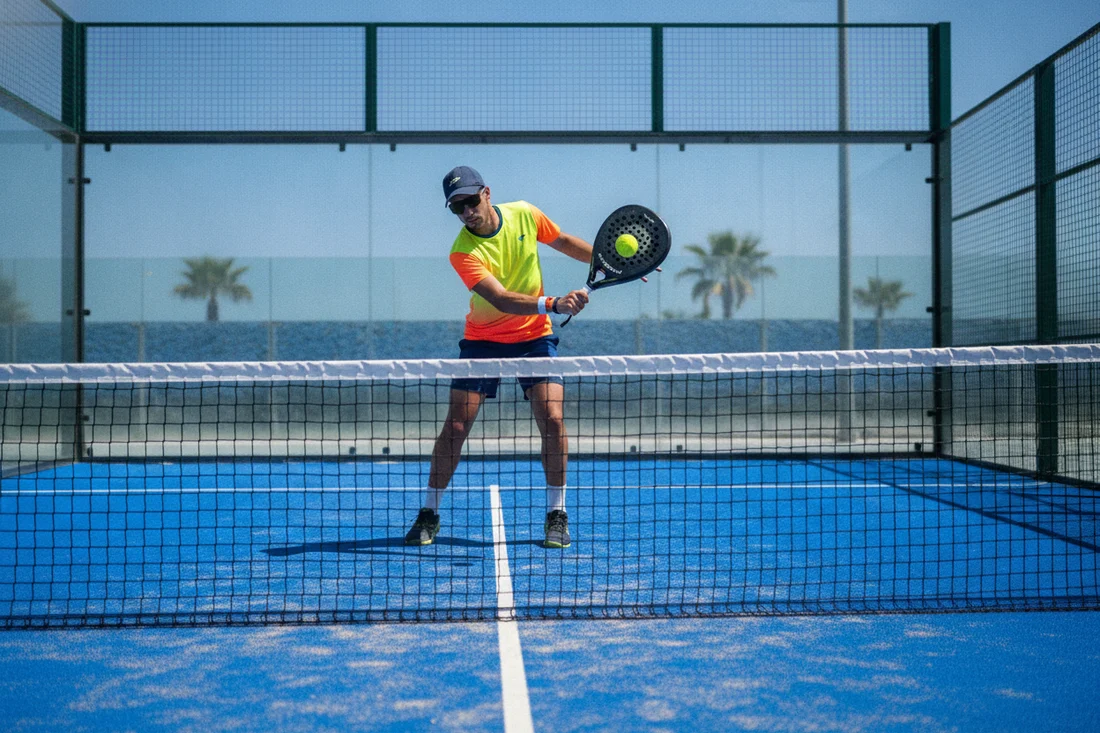 Joueur de padel dominant au filet en volee